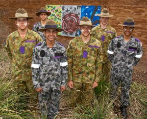 Indigenous Pre-Recruit Program participants with their artwork during the Yarning Circle Opening